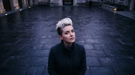 Woman With Platinum Pixie Cut in Courtyard